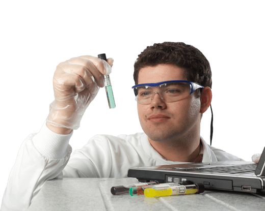 Analyst looking at a water sample with laptop