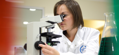 Image of an anthrax analyst with microscope