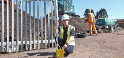 Asbestos consultant completing air testing at a site