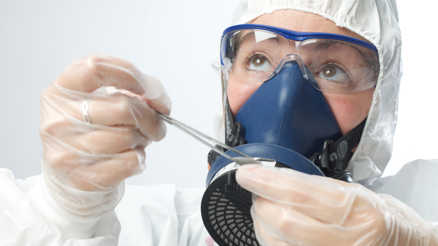 Asbestos Consultant assessing a slide as part of an expert witness investigation