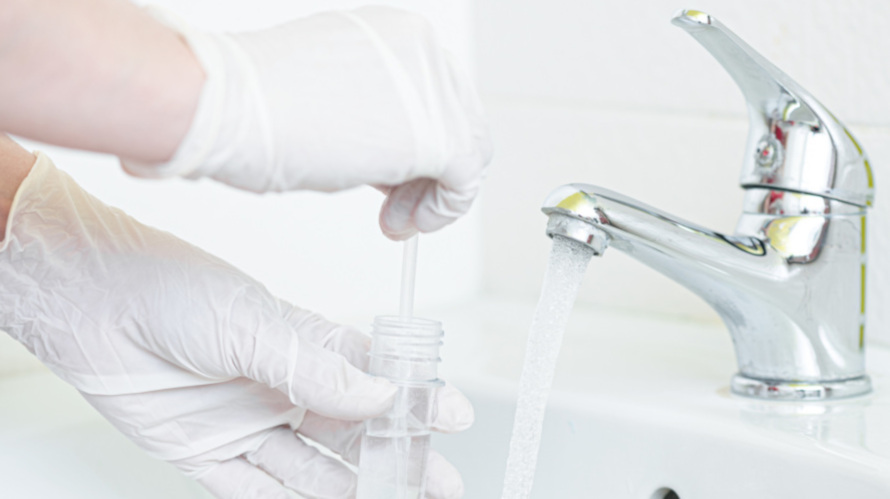 Water sample being collected from a sink for a Legionella monitoring test