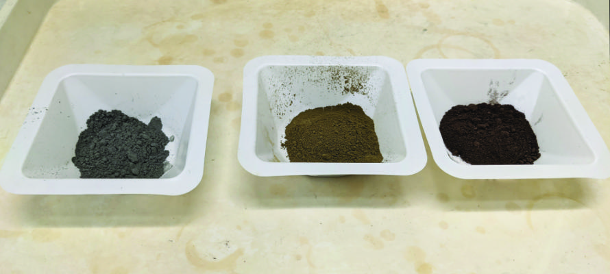 Three mine tailings samples in white sample trays.