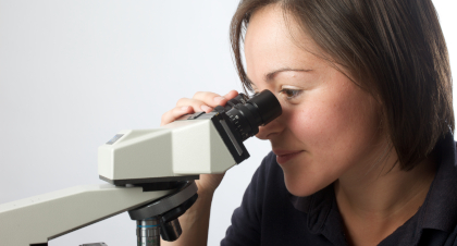 Consultant looking into a microscope